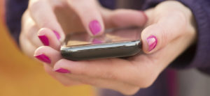 TEXTING-WOMAN-HANDS-e1456870430481-1220x560